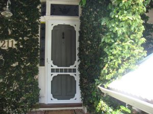 Flyscreen installed on a white coloured colonial security front door.