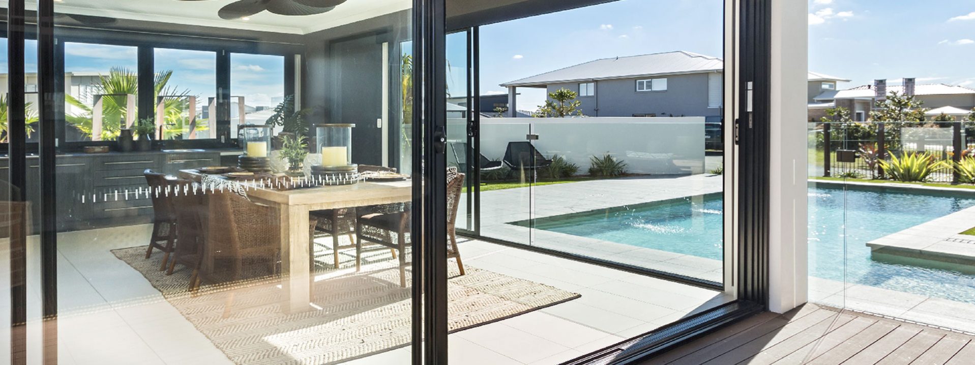 Full-length aluminium sliding security screen windows located within a Perth backyard.